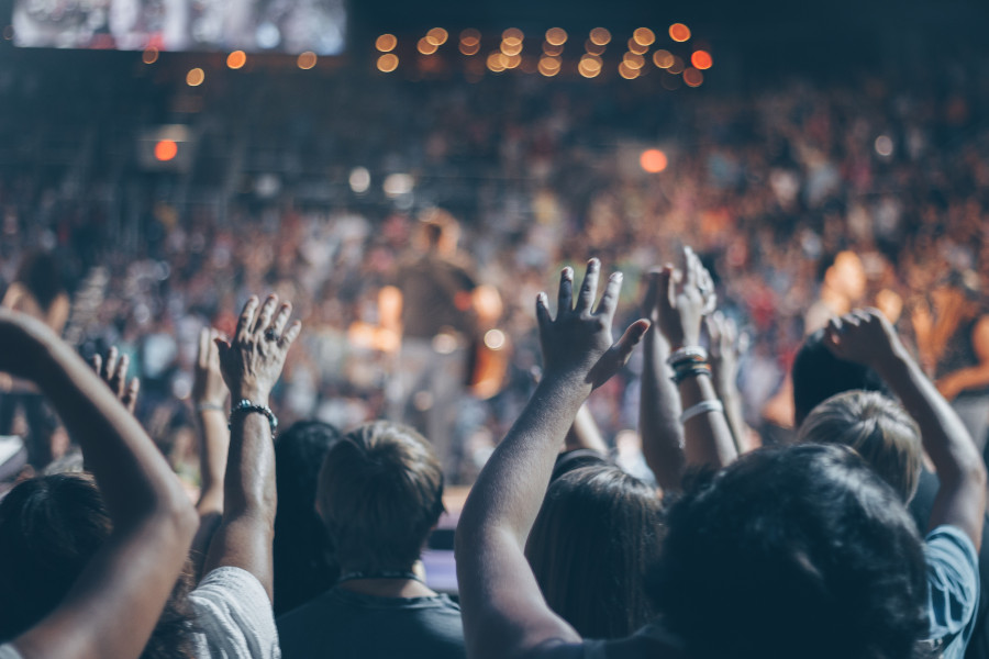 selectively focused picture of an audience at a concert. Get an overall picture when figuring out your audience