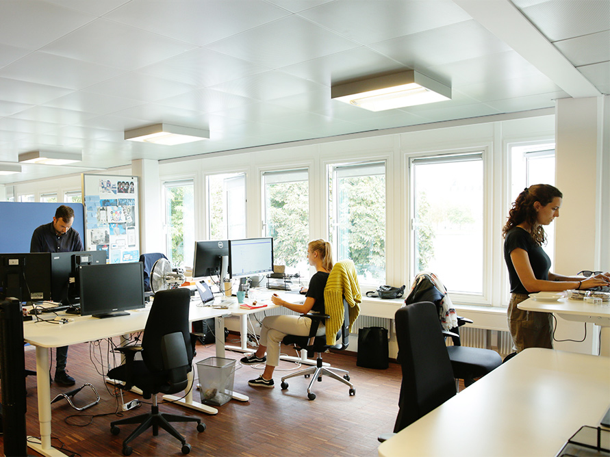 A photo of the Debitoor office with employees working at their desks