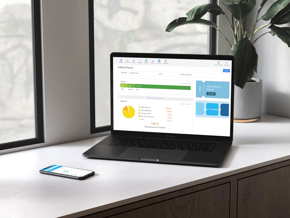 Easy to use invoicing & bookkeeping software like Debitoor shown on this laptop and smartphone make it easy to run your business from anywhere