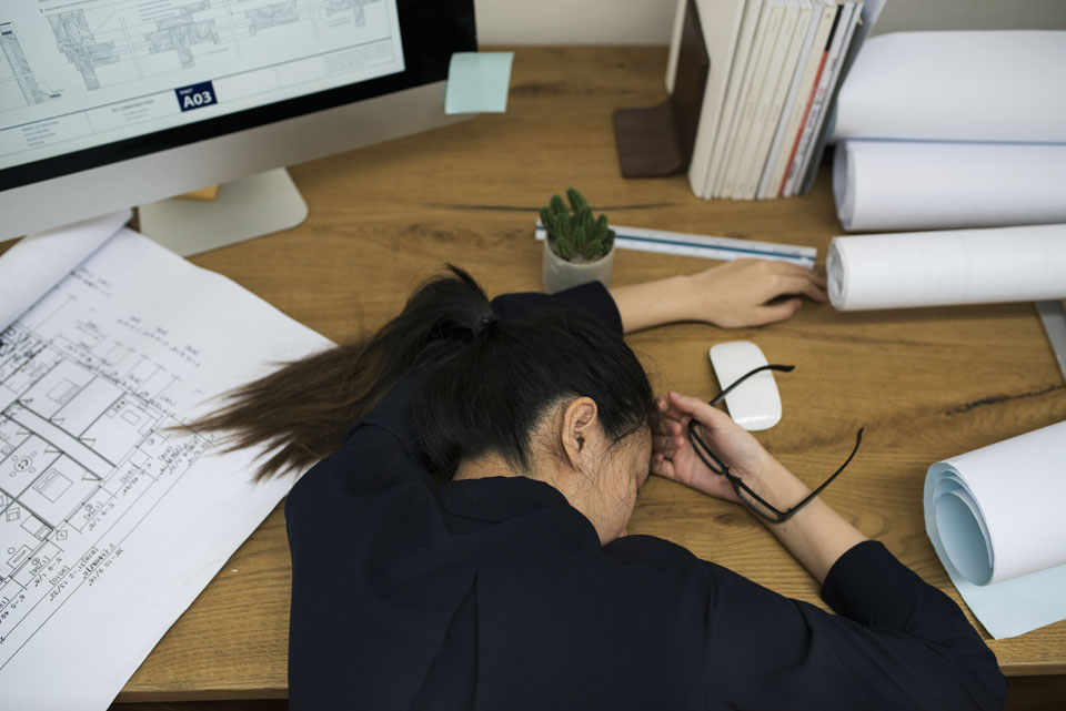 Don't take on everything yourself and fall asleep at your desk like this woman. The right employees and accounting & invoicing software can help.