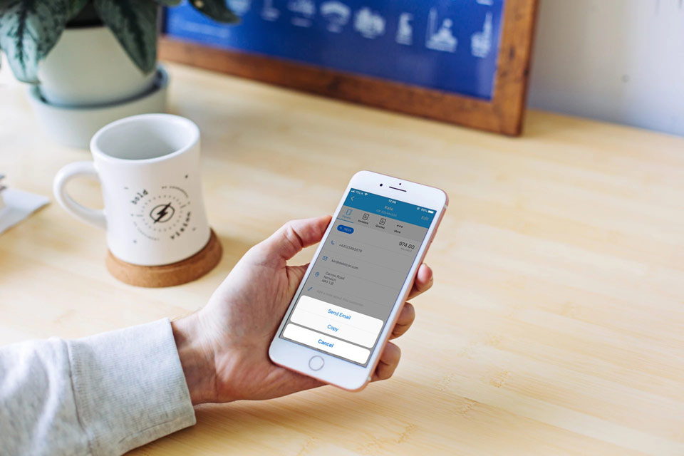 A Debitoor user contacting a client through the Debitoor iOS app