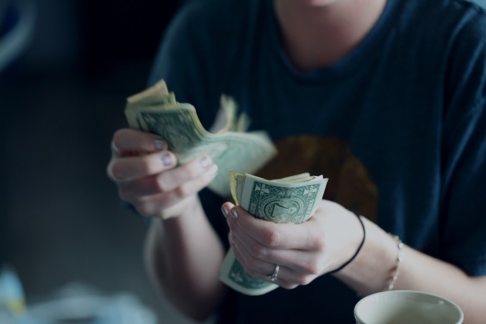 A photo of a women counting cash