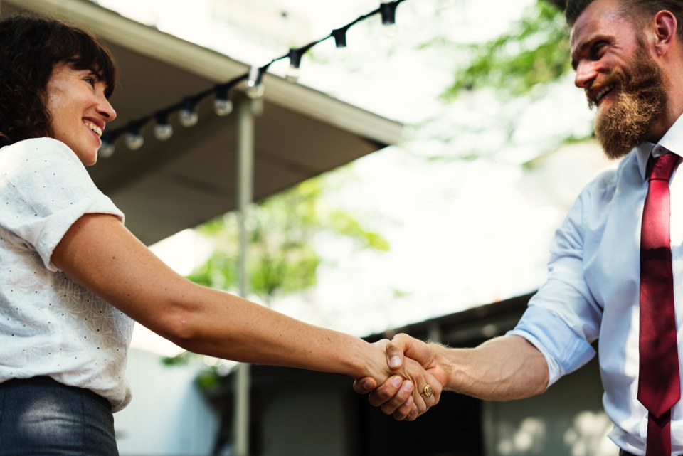 A photo of two people shaking hands