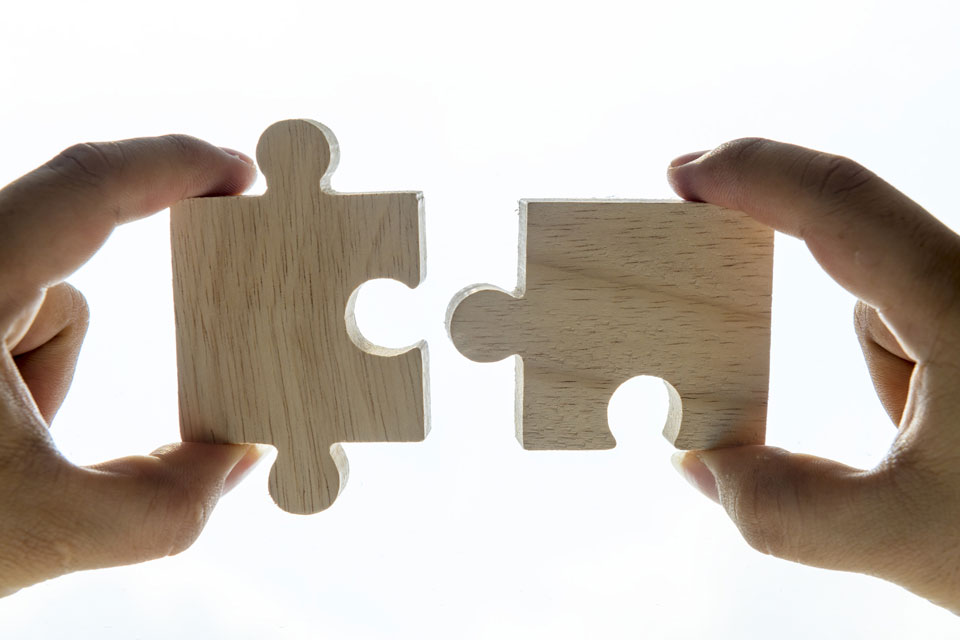 Two puzzle pieces matching together like a payment and an expense in bank reconciliation