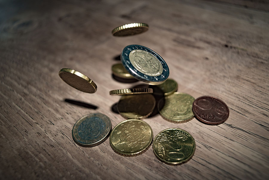 image of euro coins falling onto table- every cent helps when saving | Debitoor Invoicing and Accounting