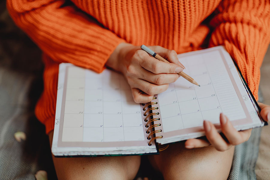 image of a woman marking a date in a calendar