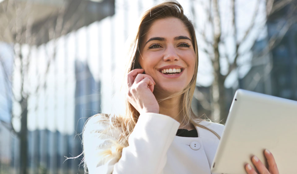 Woman happy to be using her iPad. Maybe because she's using Debitoor invoicing sofware :)