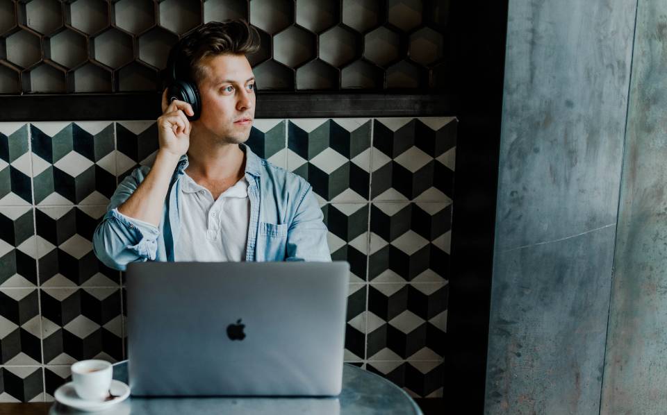 Who are your website visitors? Are they like this man in headphones looking out the window in front of a computer?